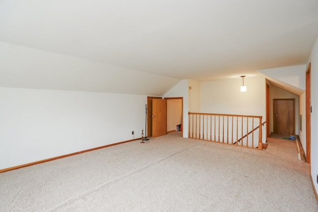 bonus room with carpet, vaulted ceiling, and baseboards