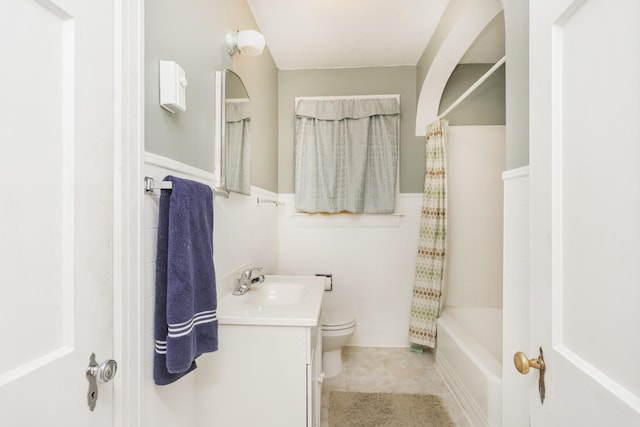 bathroom featuring shower / bath combo, tile patterned flooring, vanity, and toilet