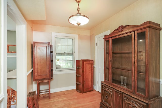 interior space featuring light wood-style flooring and baseboards