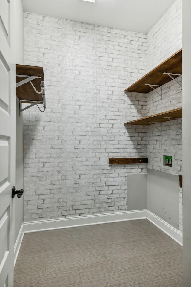 washroom with baseboards and laundry area