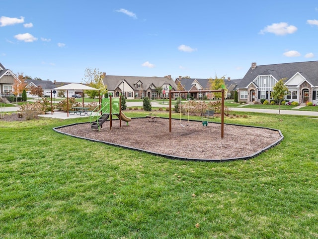 community play area with a lawn and a residential view