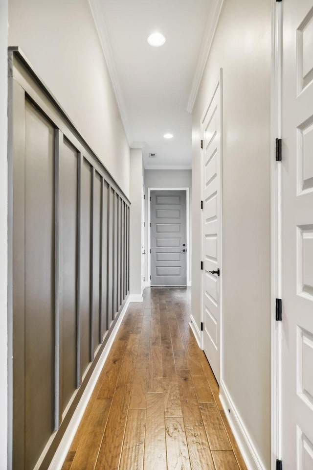 hall with recessed lighting, baseboards, crown molding, and hardwood / wood-style flooring