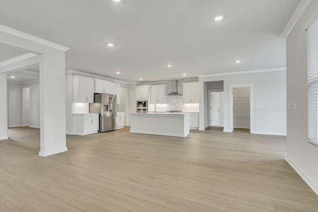 unfurnished living room with baseboards, recessed lighting, light wood-style flooring, and crown molding