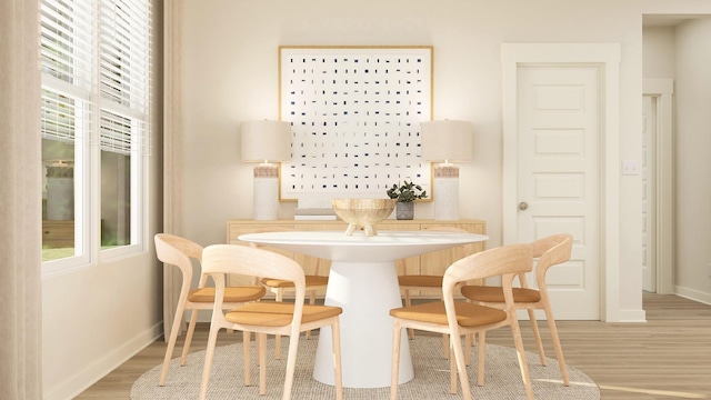 dining space featuring light wood finished floors and baseboards