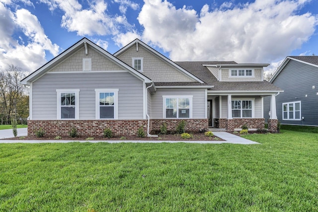 craftsman-style home featuring brick siding and a front lawn