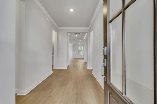 hallway with baseboards, visible vents, crown molding, light wood-style floors, and recessed lighting