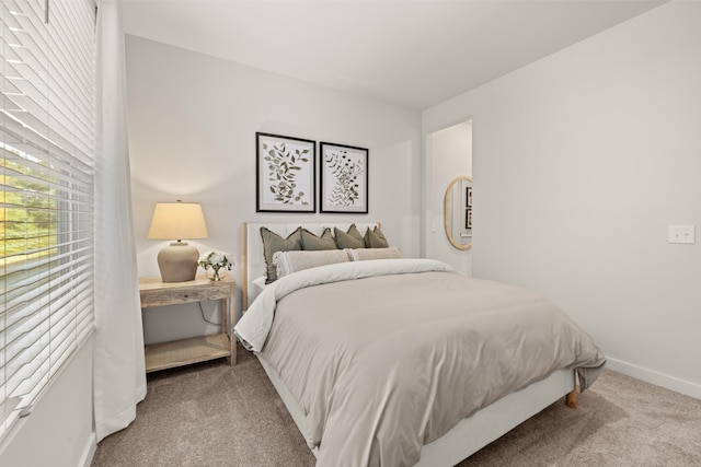 bedroom featuring carpet floors and baseboards