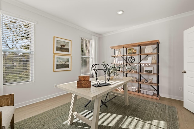 office space featuring baseboards, ornamental molding, and wood finished floors