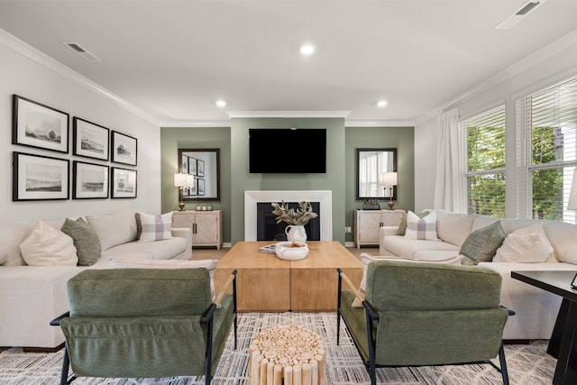 living room featuring visible vents, crown molding, and recessed lighting