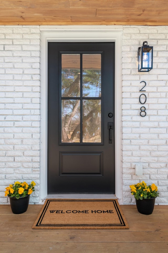 entrance to property featuring stone siding