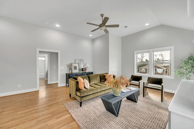 living room with baseboards, vaulted ceiling, recessed lighting, and light wood-style floors