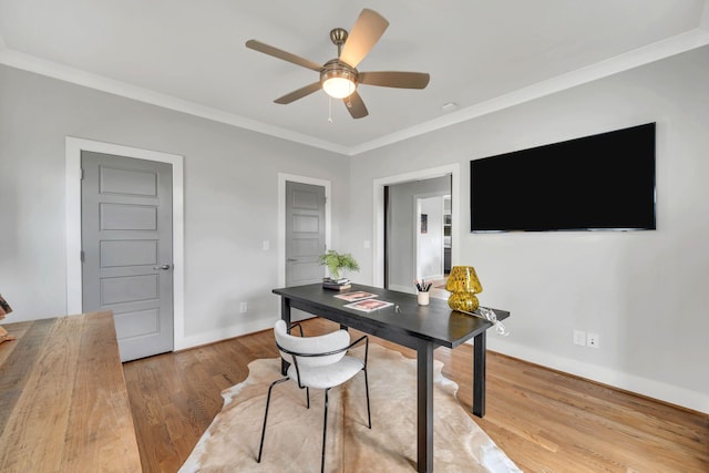 office space with crown molding, baseboards, ceiling fan, and wood finished floors