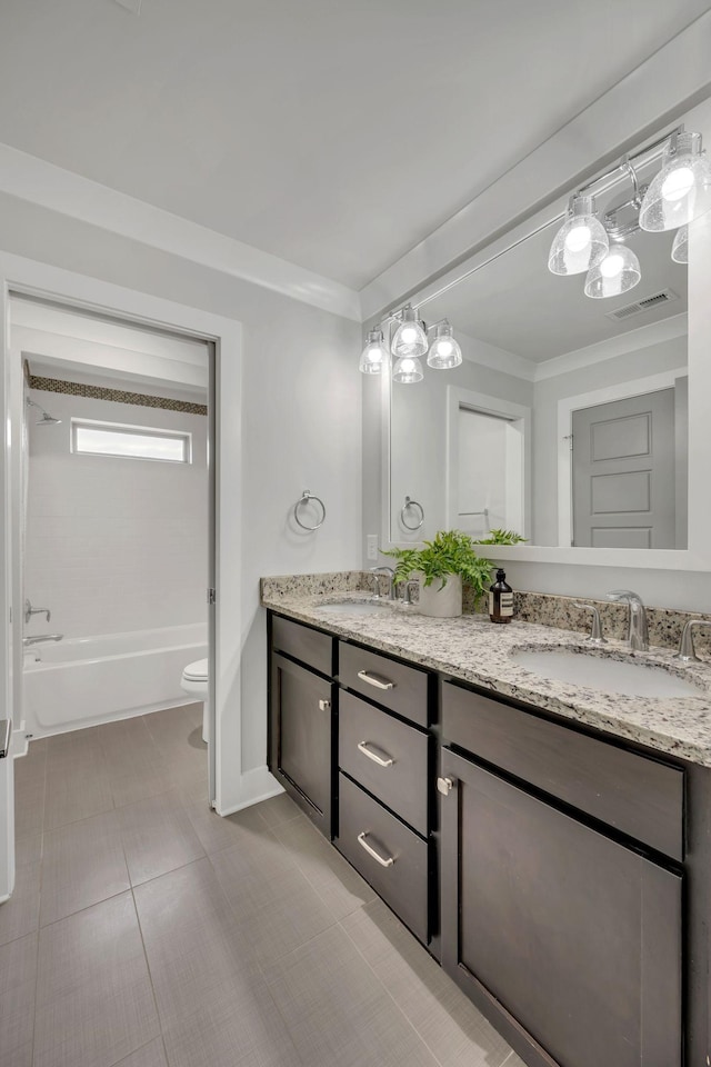 full bath with double vanity, ornamental molding, a sink, and visible vents