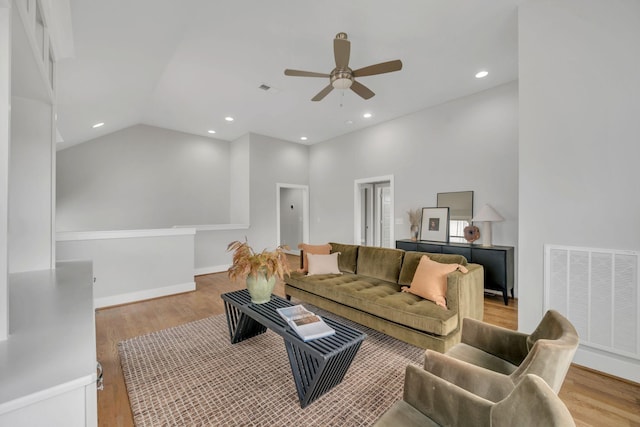 living room featuring light wood-style flooring, visible vents, baseboards, and recessed lighting