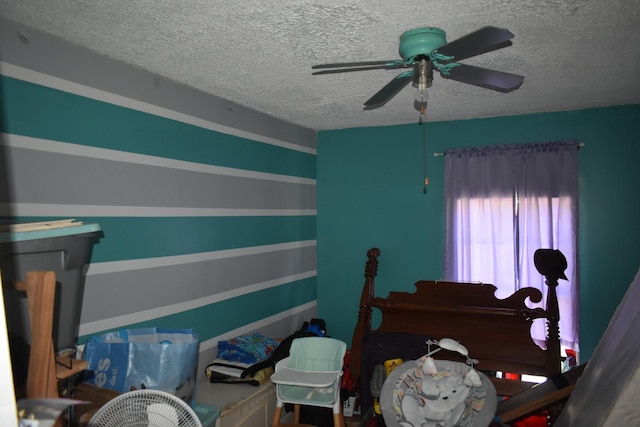 bedroom featuring ceiling fan and a textured ceiling