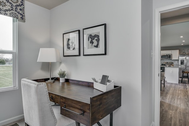 office featuring baseboards and wood finished floors