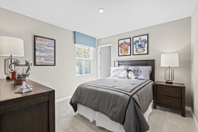 bedroom featuring baseboards and light colored carpet