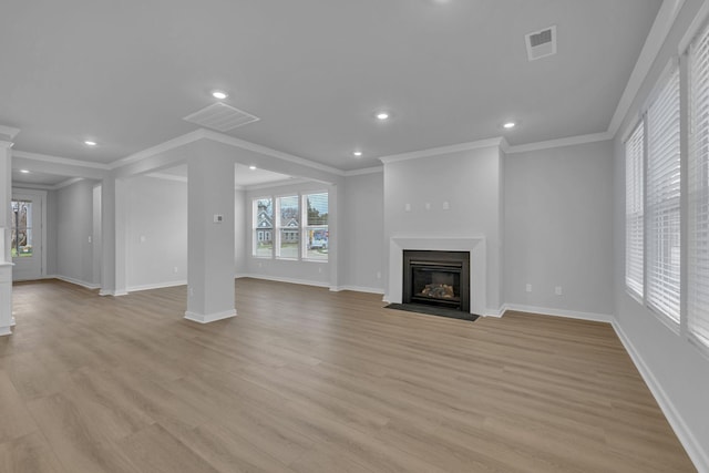 unfurnished living room with light wood finished floors, a fireplace with flush hearth, and baseboards