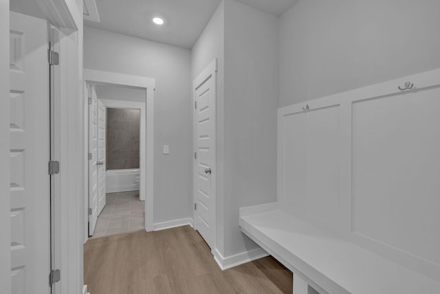 mudroom featuring baseboards and wood finished floors