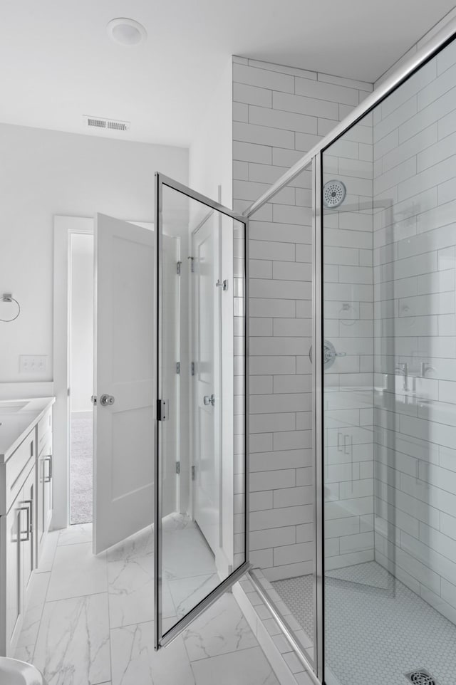 bathroom featuring a stall shower, marble finish floor, and visible vents