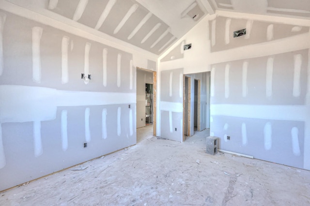 unfurnished room featuring high vaulted ceiling