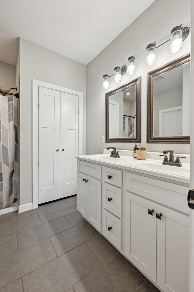 full bath with double vanity, a sink, and a shower with shower curtain