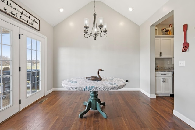 dining space with lofted ceiling, dark wood-style flooring, visible vents, and baseboards