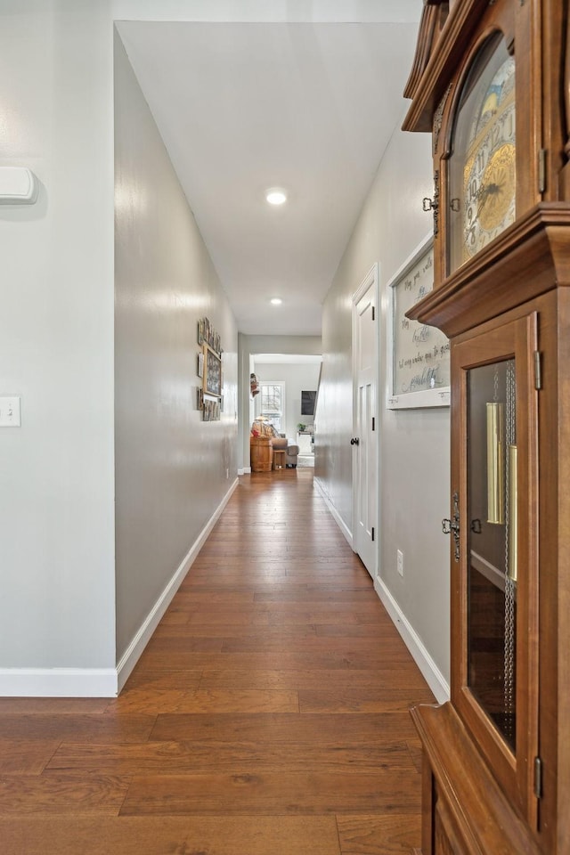 hall with hardwood / wood-style flooring and baseboards