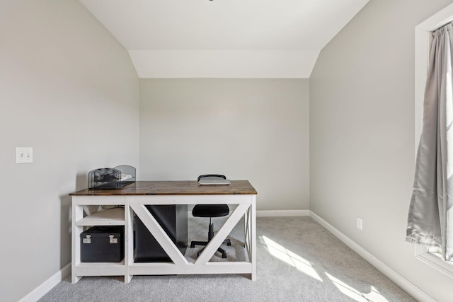 office space featuring vaulted ceiling, carpet flooring, and baseboards