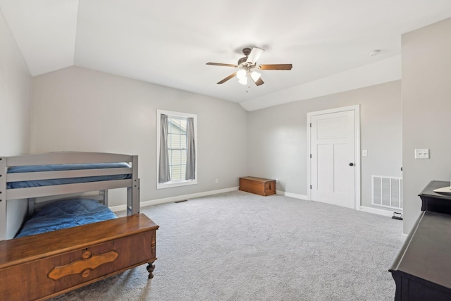 interior space featuring carpet floors, visible vents, a ceiling fan, vaulted ceiling, and baseboards