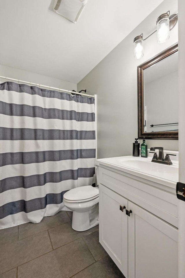bathroom with curtained shower, visible vents, toilet, vanity, and tile patterned floors