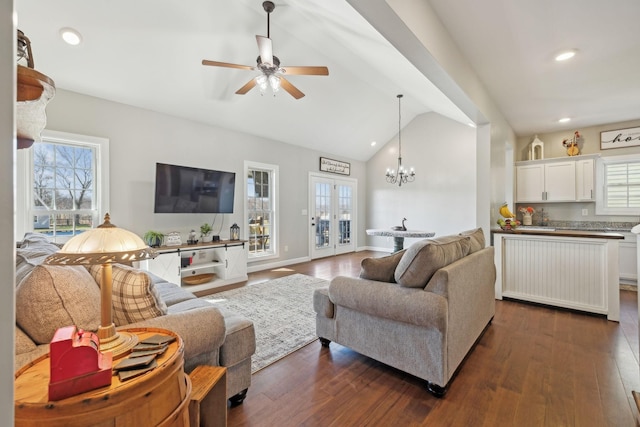 living area with recessed lighting, vaulted ceiling, dark wood finished floors, and french doors