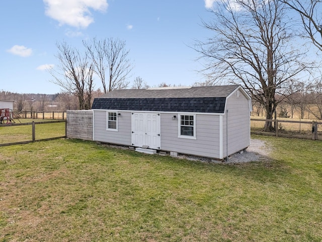 view of outdoor structure featuring an outbuilding and fence