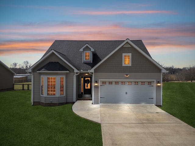 view of front of house featuring an attached garage, a shingled roof, fence, driveway, and a front lawn