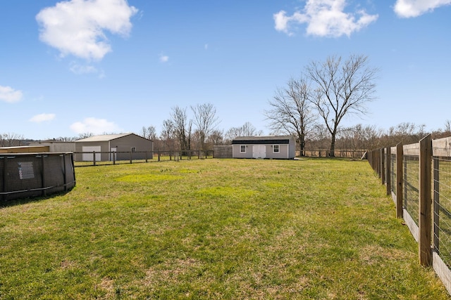 view of yard featuring a fenced backyard and an outdoor structure