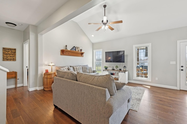 living room featuring lofted ceiling, dark wood-style floors, and plenty of natural light