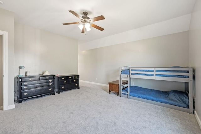 carpeted bedroom featuring baseboards and a ceiling fan