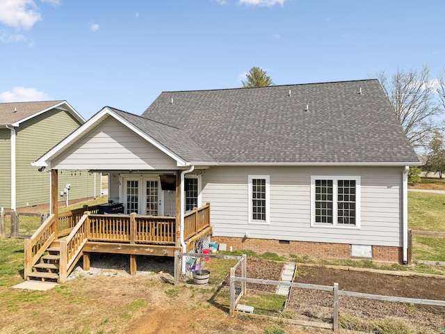 rear view of property with a deck, roof with shingles, crawl space, and fence