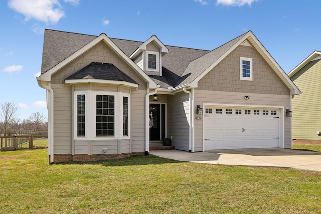 view of front of property with a garage, driveway, a front yard, and fence