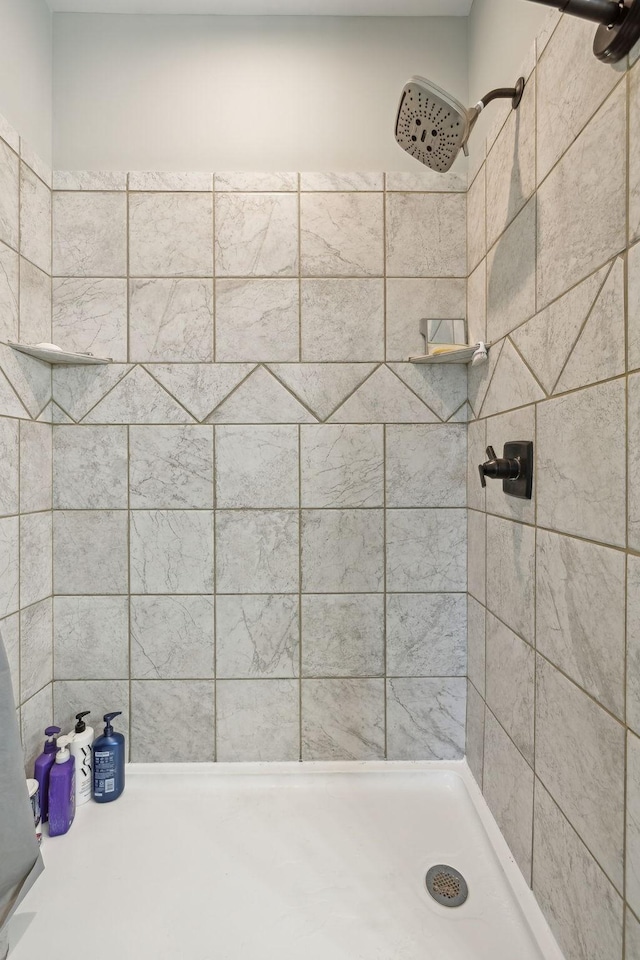 full bath with a tile shower