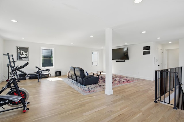 exercise room featuring recessed lighting, light wood-style flooring, and baseboards