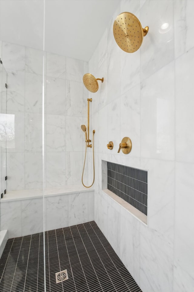 bathroom featuring visible vents and a tile shower