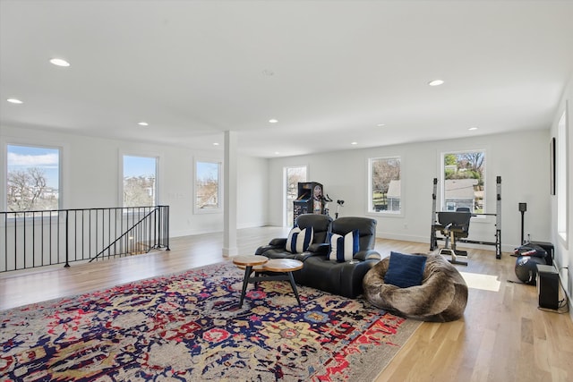 living room featuring baseboards, recessed lighting, and light wood-style floors