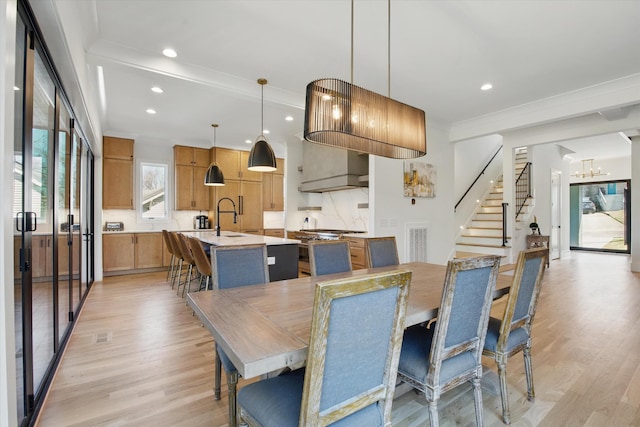 dining room with light wood finished floors, recessed lighting, visible vents, stairway, and ornamental molding