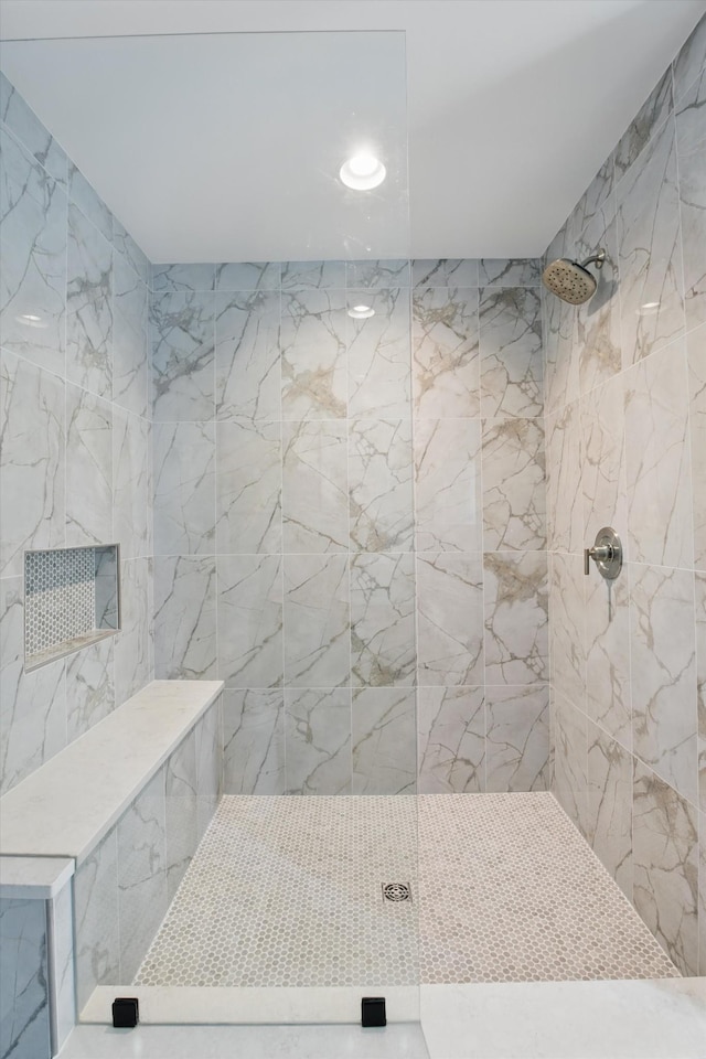 full bathroom with tiled shower