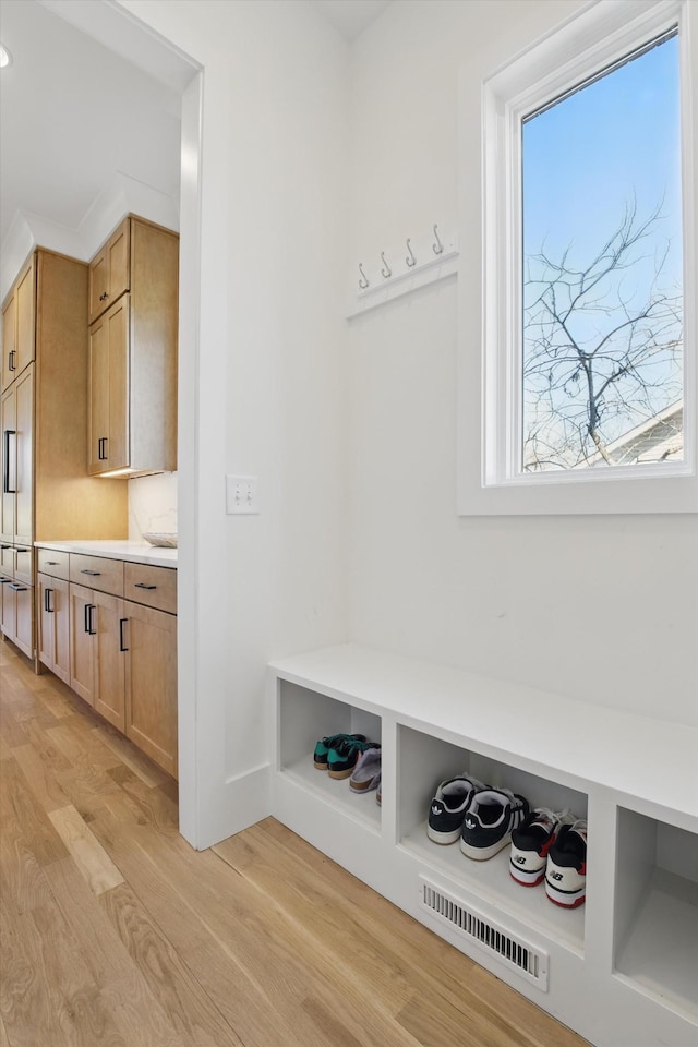 mudroom featuring light wood finished floors and visible vents