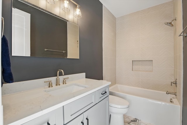 bathroom with vanity, bathtub / shower combination, and toilet