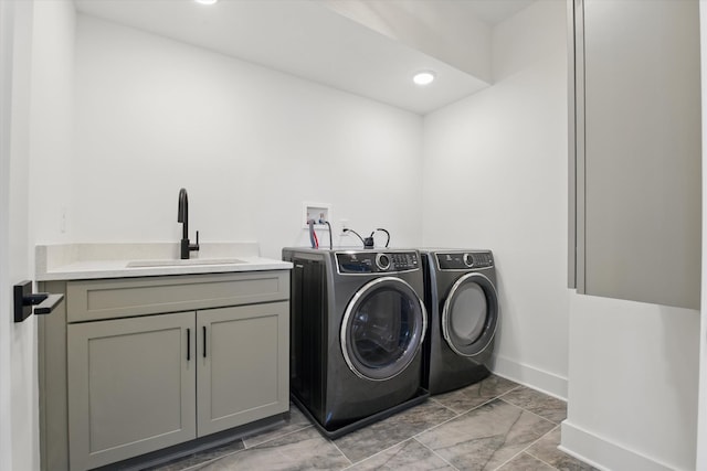 laundry area with cabinet space, baseboards, washer and clothes dryer, a sink, and recessed lighting