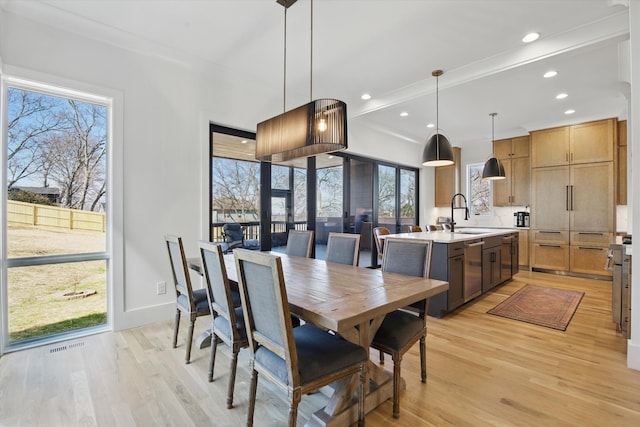 dining space with light wood-style floors, recessed lighting, and baseboards