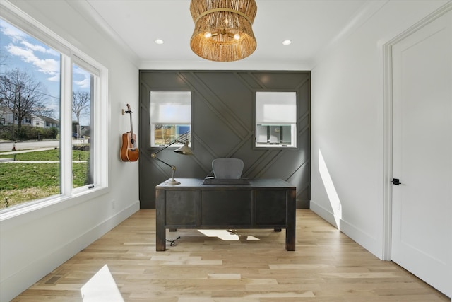 home office featuring light wood-style floors, a notable chandelier, baseboards, and ornamental molding